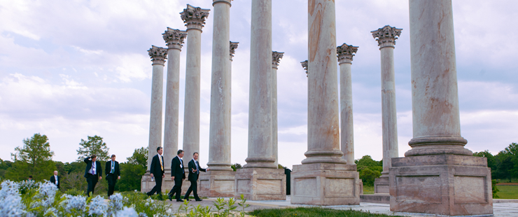 Groomsman among the capital columns